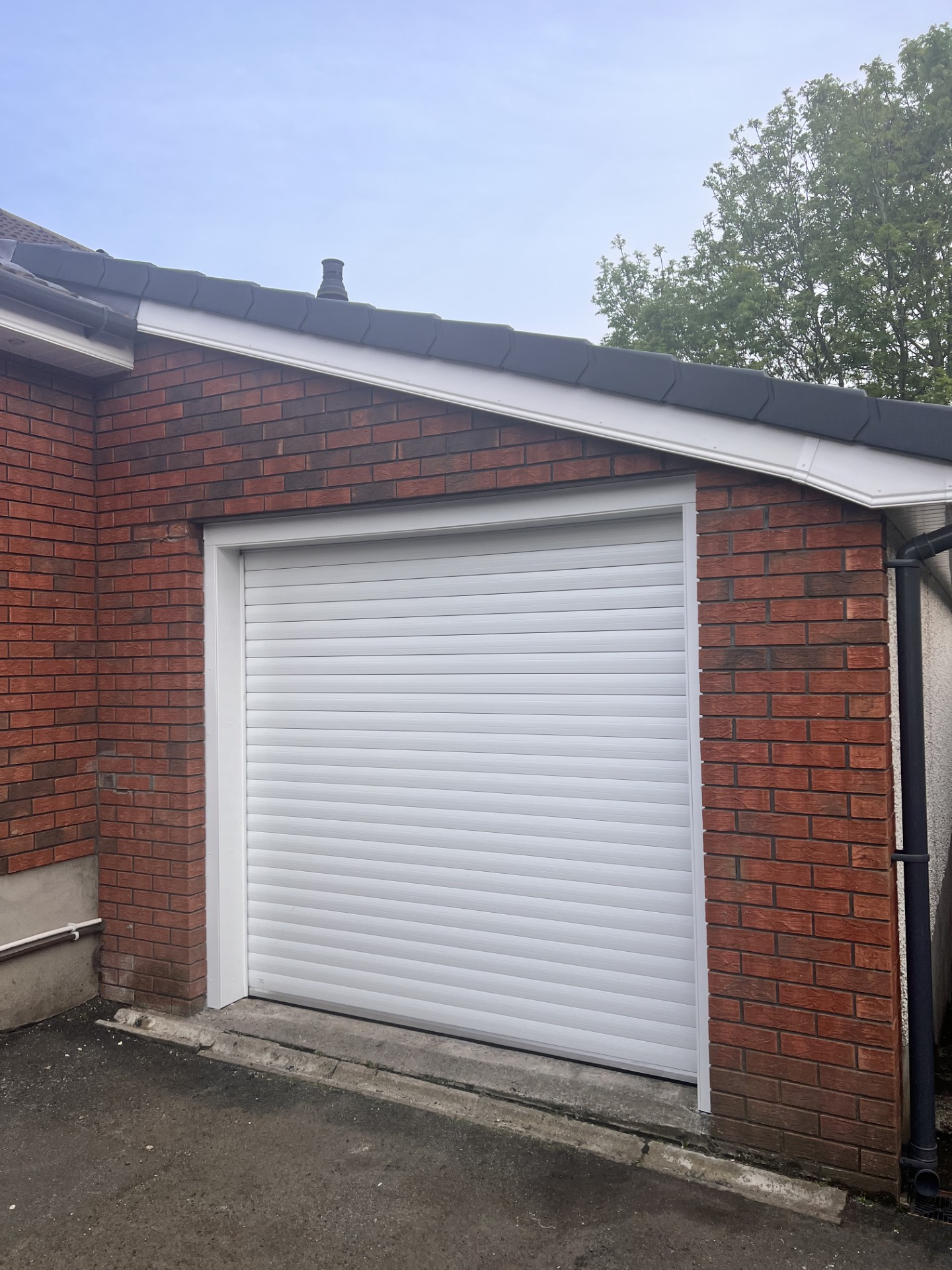 White roller garage door installation by Overhead Door Company